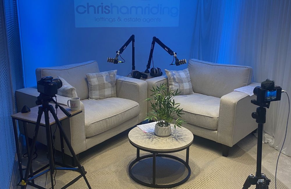TAE Podcast studio set with sofas, podcast microphones and cameras